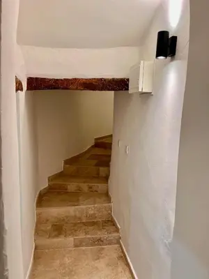 a staircase in a house with wooden floors at coeur du Luberon in Lourmarin