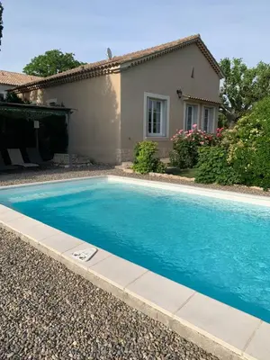 a swimming pool in front of a house at Mas des Lubières in Saint-Rémy-de-Provence