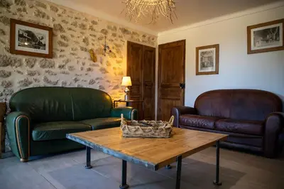 a living room with two couches and a coffee table at sous la glycine de costebelle in Cheval-Blanc