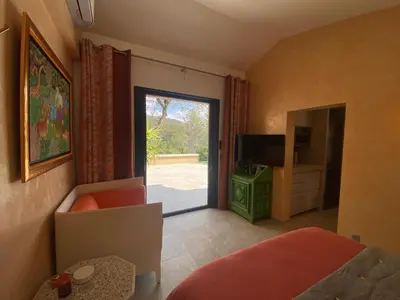 a bedroom with a door leading to a patio at Studio climatisé - Terrasse, Plancha, Fibre in Aix-en-Provence