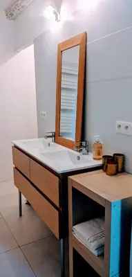 a bathroom with a sink and a mirror at Chambre Voltaire ou Chambre Beckett, terrasse en bord de Sorgue in Le Thor