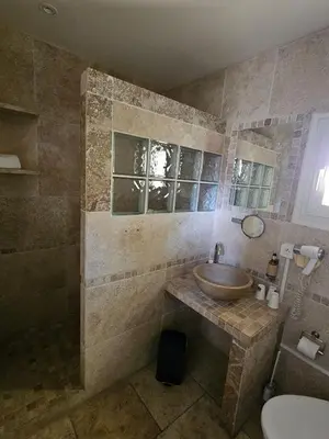 a bathroom with a sink and a toilet and a tub at La madone in La Tour-dʼAigues