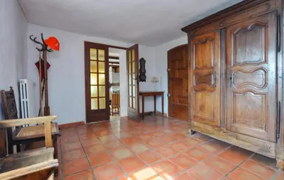 a room with a large wooden cabinet and a table at Stunning Home In Vacheres in Vachères