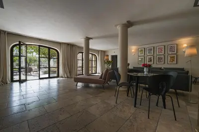 a living room with a couch and a table and chairs at Mas Naste in Eygalières