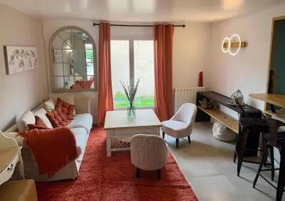 a living room with a table and some chairs at Le clos de l’artichaut in Eyguières
