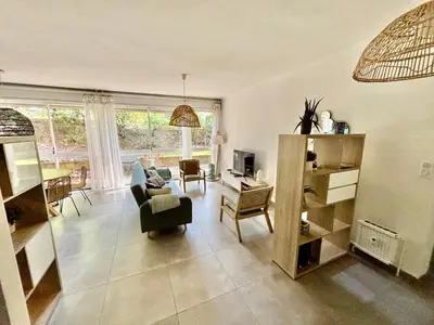 a living room with a couch and a chair at Magnifique T2 avec Terrasse in Aix-en-Provence