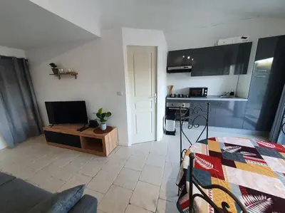 a room with a kitchen and a living room at Havre de paix au bord des Alpilles in Eyguières