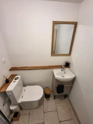 a bathroom with a white toilet and a sink at Havre de paix au bord des Alpilles in Eyguières