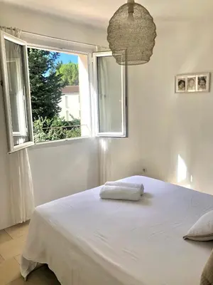 a bedroom with a large white bed with two pillows at Hope, villa à Aix en Provence in Aix-en-Provence