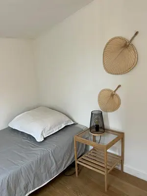 a bedroom with a bed and a nightstand with a table at Hypercenter lovely duplex with Terrace CLIM WIFI in Aix-en-Provence