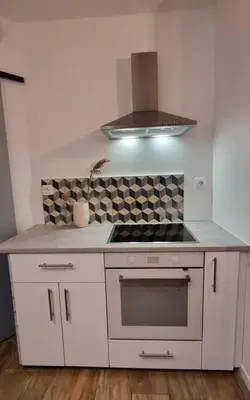 a kitchen with a stove and a stove top oven at Appartement Confortable & Lumineux in Lambesc