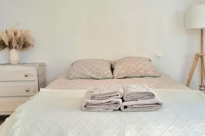a bedroom with a bed with towels on it at Appartement Confortable & Lumineux in Lambesc