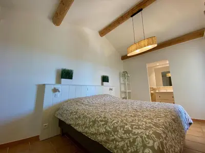 a bedroom with a bed in a room at La Bastide au Ventoux in Bédoin
