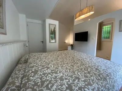 a bedroom with a large bed in a room at La Bastide au Ventoux in Bédoin
