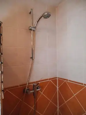 a shower with a shower head in a bathroom at Maison de campagne avec Piscine in Pernes-les-Fontaines