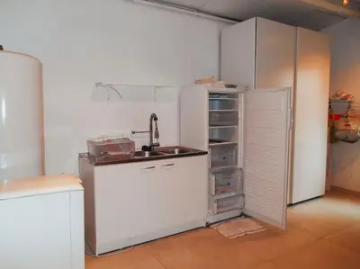 a kitchen with a sink and a refrigerator at Maison de campagne avec Piscine in Pernes-les-Fontaines
