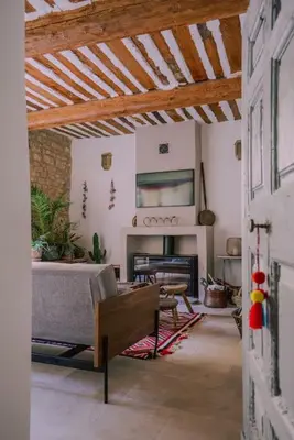 a living room with a couch and a fireplace at Grande maison de charme au coeur de Goult in Goult