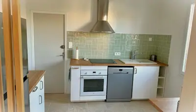 a kitchen with a sink and a stove at Villa la Farigoule in Carpentras