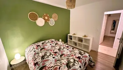 a bedroom with a bed and a green wall at Villa la Farigoule in Carpentras