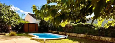 a small swimming pool in a yard next to a fence at Villa la Farigoule in Carpentras
