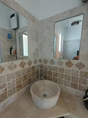 a bathroom with a tub and a large mirror at Luberon sud in La Bastidonne
