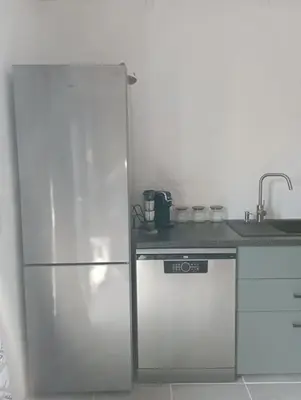 a kitchen with a white refrigerator and a sink at maisonnette provençale piscine le petit colibri in Les Cordiers