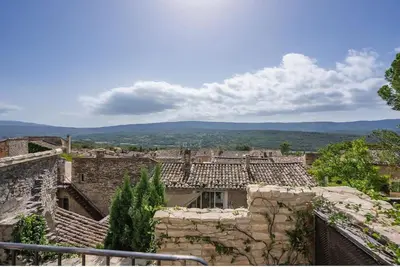 a view of an old town with buildings and trees at Maison d'exception au cœur de Goult in Goult