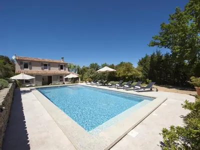 a swimming pool in front of a villa at Les Blayons - Exclusive Pool Villa Stunning View in Bonnieux