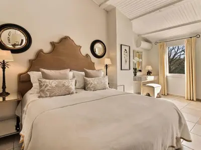 a bedroom with a large bed and a window at Les Blayons - Exclusive Pool Villa Stunning View in Bonnieux
