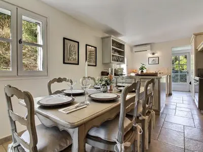 a kitchen and dining room with a table and chairs at Les Blayons - Exclusive Pool Villa Stunning View in Bonnieux