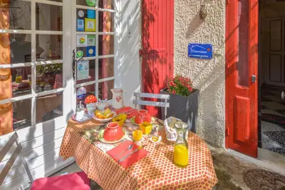 a table with a plate of food on it at Chambres d'hôtes 