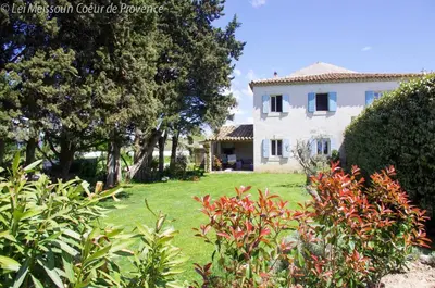 a large white house with trees and a yard at Lei Meissoun in Mallemort