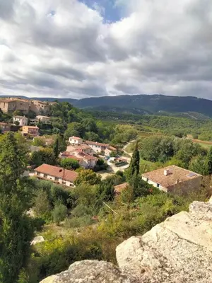 a small town in the hills with houses and trees at Nature in Cabrières-dʼAigues