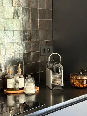 a kitchen counter with a sink with a toaster at Le petit Auzon in Mazan