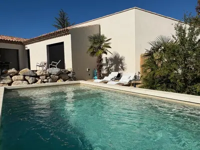 a swimming pool in front of a house at Le petit Auzon in Mazan