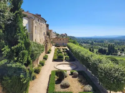 an aerial view of a garden in front of a building at Les voûtes du vieux village in Lauris