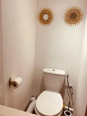 a bathroom with a toilet and two mirrors on the wall at Studio Oasis de paix centre Aix en Provence in Aix-en-Provence