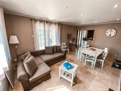 a living room with a couch and a table at La Petite Colline in Apt