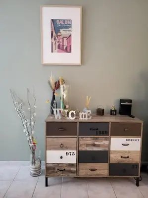 a wooden dresser in a room with a picture on the wall at Le temps d'un instant in Salon-de-Provence