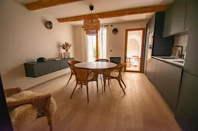 a kitchen and dining room with a table and chairs at Le Baudelaire - magnifique appartement au cœur du centre historique in Aix-en-Provence
