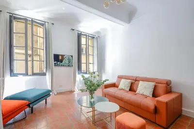 a living room with a couch and a table at Élégant Appartement Standing à 3min du Cours Mirabeau in Aix-en-Provence