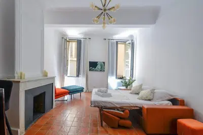 a living room with a bed and a fireplace at Élégant Appartement Standing à 3min du Cours Mirabeau in Aix-en-Provence