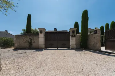 a house with a gate and a driveway at Studio at Mas Naste in Eygalières