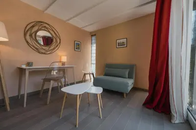 a living room with a table and a chair at Studio at Mas Naste in Eygalières