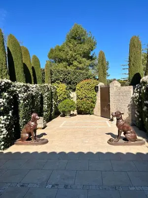 two bronze statues of dogs in a garden at Studio at Mas Naste in Eygalières