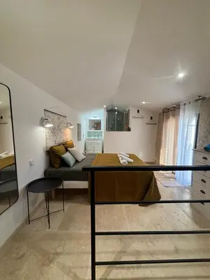 a room with a bed and a table in it at Charmante maison Provençale avec grand jardin in LʼIsle-sur-la-Sorgue