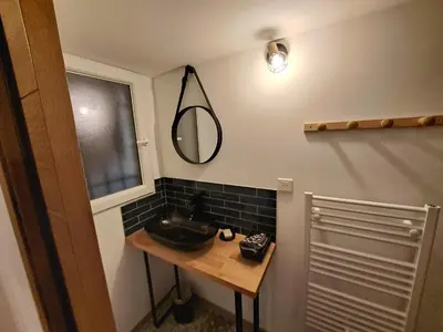a bathroom with a sink and a mirror on the wall at Gîte Le Dodo in Lançon-Provence