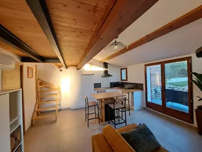 a living room with a couch and a table at Gîte Le Dodo in Lançon-Provence