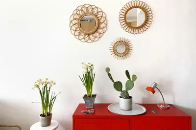 a red dresser with plants and mirrors on a wall at Appartement Vieille ville 55 m2 avec Terrasse 16m2 et 2chambres Vraie Climatisation in Aix-en-Provence