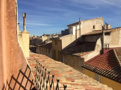 a view of an alley with buildings and a fence at Appartement Vieille ville 55 m2 avec Terrasse 16m2 et 2chambres Vraie Climatisation in Aix-en-Provence